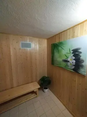 a room with a bench and a painting on the wall at Počitniška hiša Lokve in Trnovo