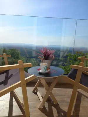 a table with a cup and a potted plant on it at Vineyard cottage foggy sea in Semič
