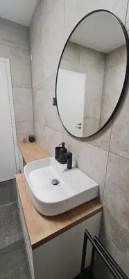 a bathroom with a white sink and a mirror at Charming Bovec Apartment in Bovec