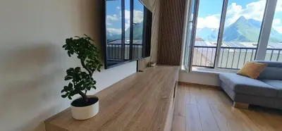 a living room with a couch and a potted plant at Charming Bovec Apartment in Bovec