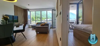 a living room with a bed and a couch and a table at Charming Bovec Apartment in Bovec
