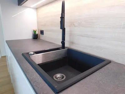 a sink in a kitchen with a counter top at Charming Bovec Apartment in Bovec
