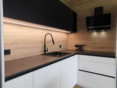 a kitchen with white cabinets and a sink at Charming Bovec Apartment in Bovec