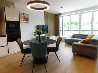a living room with a table and a couch at Charming Bovec Apartment in Bovec