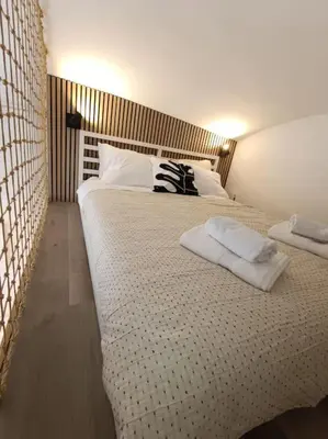 a bedroom with a large bed with two pillows on it at One-bedroom city apartment in Ljubljana
