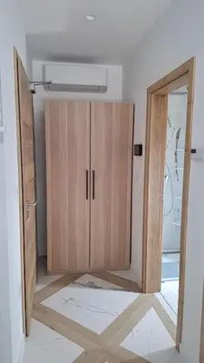 a room with a wooden cabinet in a room at Downtown Delight in Ljubljana