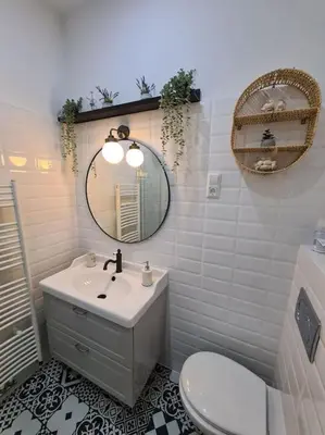 a bathroom with a sink and a mirror and a toilet at Oldie goldie in Maribor