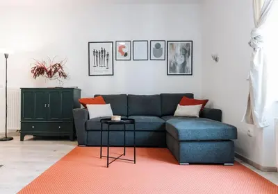 a living room with a blue couch and a table at Oldie goldie in Maribor