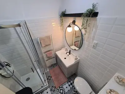a bathroom with a sink and a toilet and a shower at Oldie goldie in Maribor