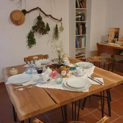 a wooden table with plates and dishes on it at River House Radolca in Radovljica