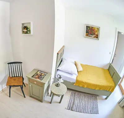a bedroom with a bed and a table and a chair at River House Radolca in Radovljica