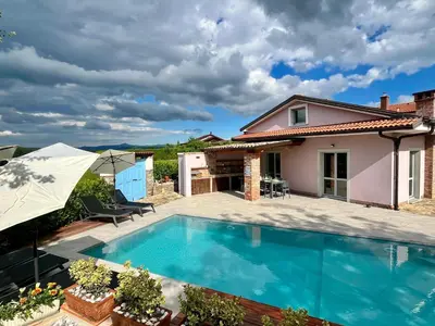 a villa with a swimming pool and a house at Resort Franko Spacious house with a pool in Obrov