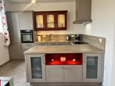a kitchen with a counter with two apples on it at Resort Franko Spacious house with a pool in Obrov
