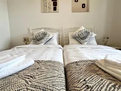two beds sitting next to each other in a bedroom at Resort Franko Spacious house with a pool in Obrov