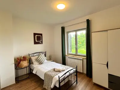 a bedroom with a bed and a window at Resort Franko Spacious house with a pool in Obrov