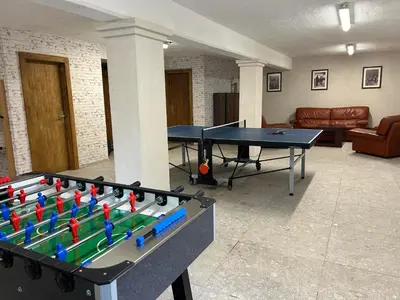 a ping pong table in the middle of a living room at Resort Franko Spacious house with a pool in Obrov