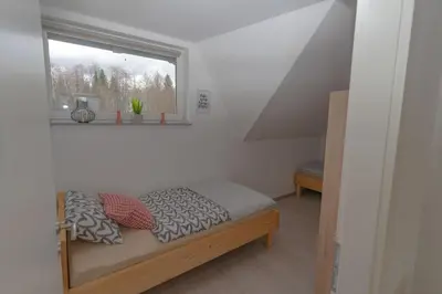 a bed in a room with a window at Apartma Fantazija in Ribnica