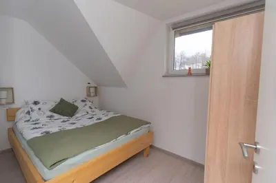 a small bedroom with a bed and a window at Apartma Fantazija in Ribnica