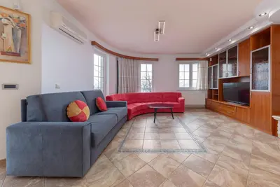 a living room with a couch and a television at Apartments Way to Heaven in Dol pri Ljubljani