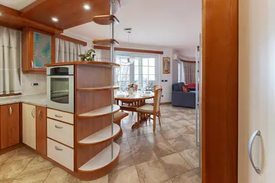 a kitchen with a table and a dining room at Apartments Way to Heaven in Dol pri Ljubljani