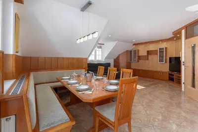 a dining room with a wooden table and chairs at Apartments Way to Heaven in Dol pri Ljubljani