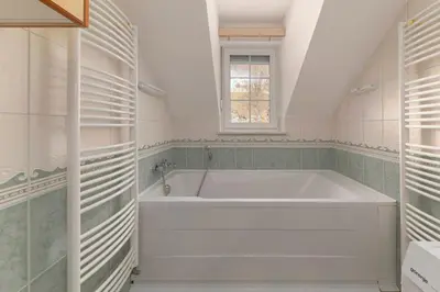 a white bath tub in a bathroom with a window at Apartments Way to Heaven in Dol pri Ljubljani