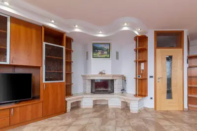 a living room with a fireplace and a tv at Apartments Way to Heaven in Dol pri Ljubljani