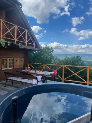 a swimming pool with a table and a picnic table at Brunarica Dežno in Makole