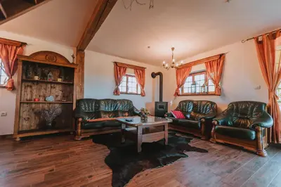 a living room with leather couches and a table at Brunarica Dežno in Makole