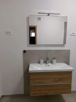 a bathroom with a sink and a mirror at Apartment with a view in Dobravlje