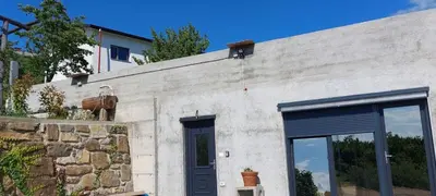 a building with a cow on the side of it at Apartment with a view in Dobravlje