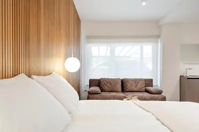 a bedroom with a bed and a couch at Bugabu Ljubljana in Ljubljana