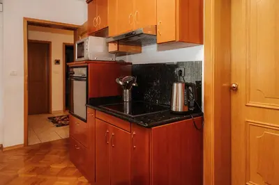 a kitchen with wooden cabinets and a counter top at Premium house Anika in Rogaška Slatina
