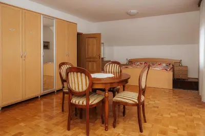 a room with a table and chairs and a bed at Premium house Anika in Rogaška Slatina