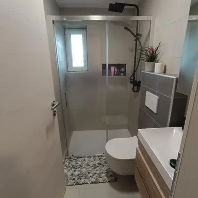 a bathroom with a shower and a toilet and a sink at Apartma z lepo teraso za 3+1 osebe in Bled