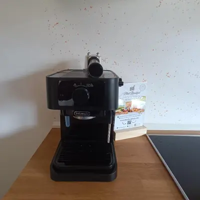 a black coffee maker sitting on top of a table at Apartma z lepo teraso za 3+1 osebe in Bled
