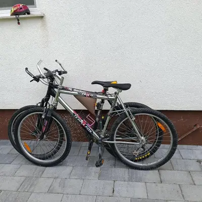 a bike parked next to a wall with a person sitting on it at Apartma z lepo teraso za 3+1 osebe in Bled