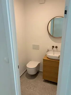a bathroom with a toilet and a sink and a mirror at Dreamy nature apartment near city-family friendly, FREE parking in Ljubljana