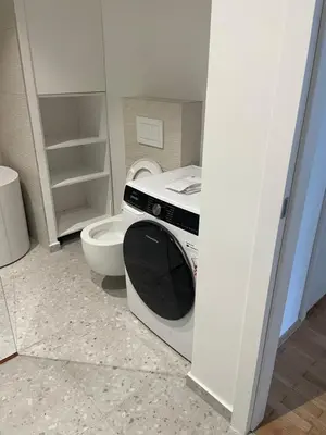a bathroom with a washing machine and a toilet at Dreamy nature apartment near city-family friendly, FREE parking in Ljubljana