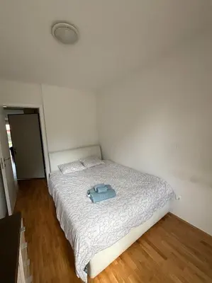 a bedroom with a bed with a blue item on it at Dreamy nature apartment near city-family friendly, FREE parking in Ljubljana