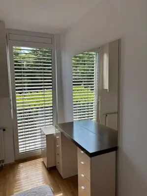 a room with a desk with a mirror and two windows at Dreamy nature apartment near city-family friendly, FREE parking in Ljubljana