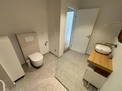 a small bathroom with a toilet and a sink at Dreamy nature apartment near city-family friendly, FREE parking in Ljubljana