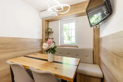 a small dining room with a table and a tv at Apartment Tina - Lipa 33 in Podčetrtek