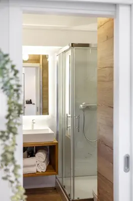 a bathroom with a glass shower and a sink at Apartment Tina - Lipa 33 in Podčetrtek