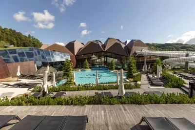 a resort with a swimming pool and a building at Apartment Tina - Lipa 33 in Podčetrtek
