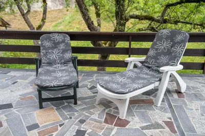 two chairs sitting next to each other on a patio at Apartments Dominika Štros in Bohinj