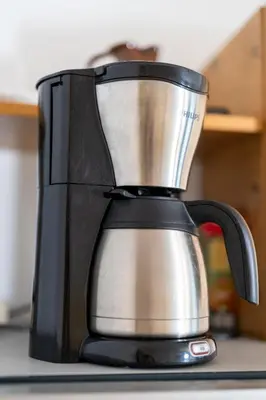 a black and silver coffee maker sitting on a counter at Apartments Dominika Štros in Bohinj