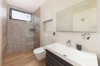 a bathroom with a toilet and a sink and a shower at Apartma Lajf in Brežice