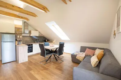 a living room with a couch and a table at Forest Breeze Apartments in Blejska Dobrava
