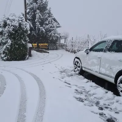a car parked on the side of a snow covered road at TRUTH WINES HOUSE in Veliki Vrh